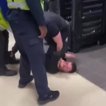 Man fighting with security, member of public takes things into his own hands.