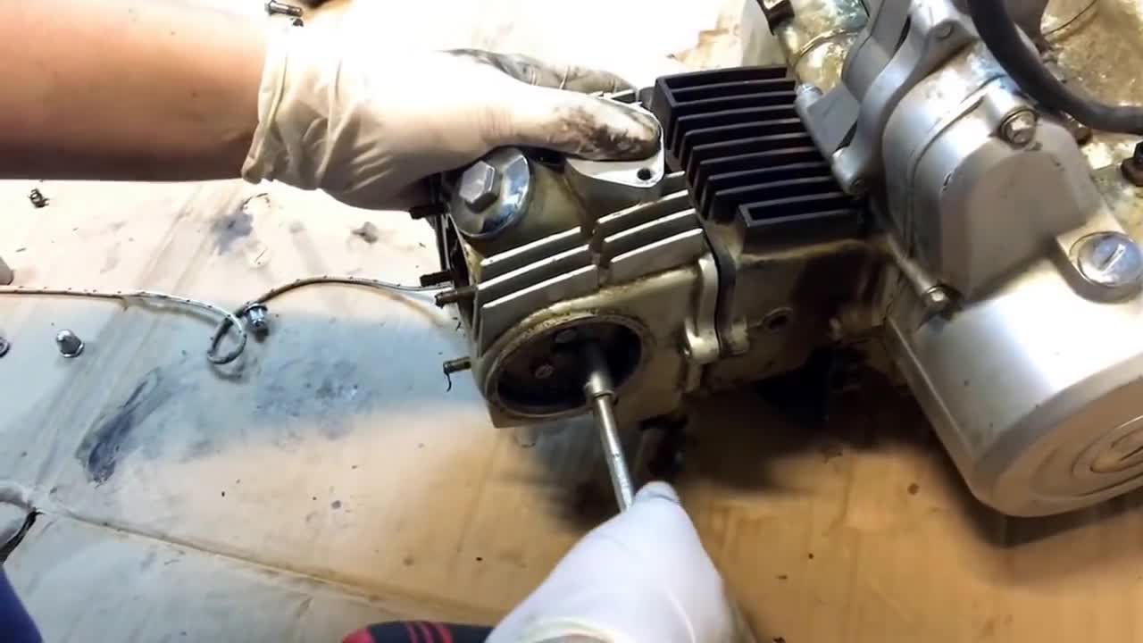 Disassembled engine and cylinder head on ATV 107 110 125 cc