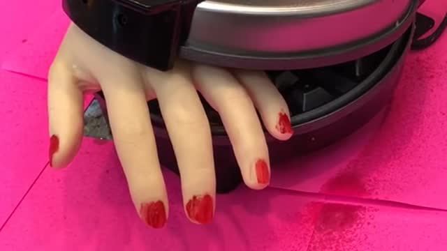 Look what the waffle iron does to her hand!!