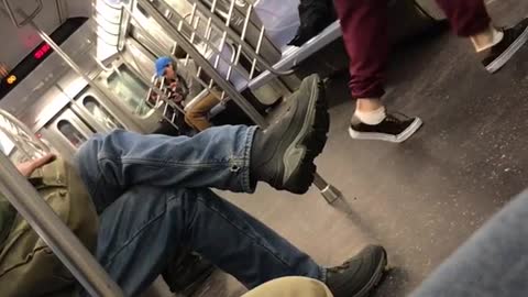Red track pants headphones guy dances up and down subway car
