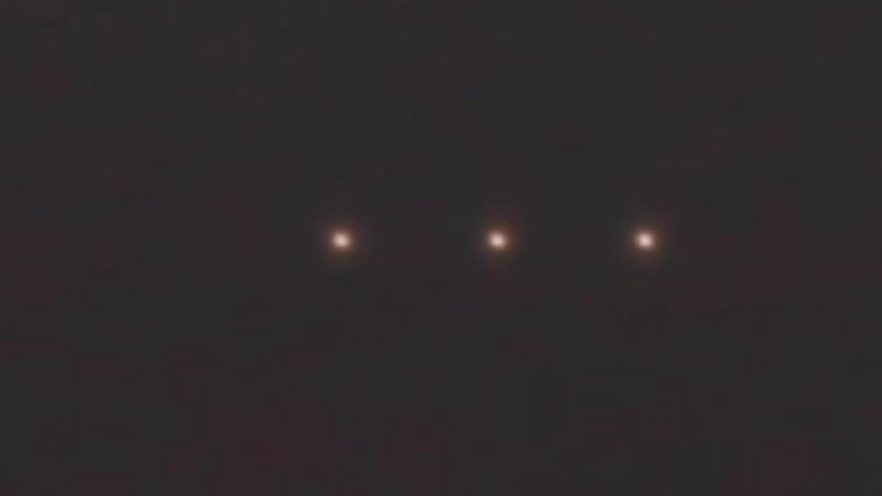 Three Perfectly Aligned Light Orbs Floating Over The Night Skies