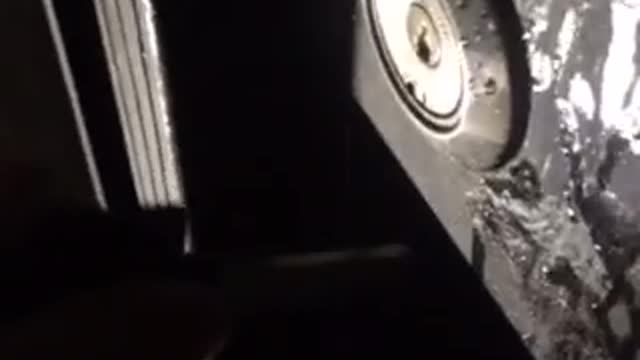 Guys trying to break into a lock at night