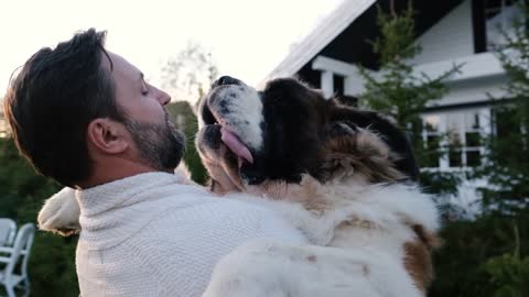 Friendship concept, man and big dog hugging