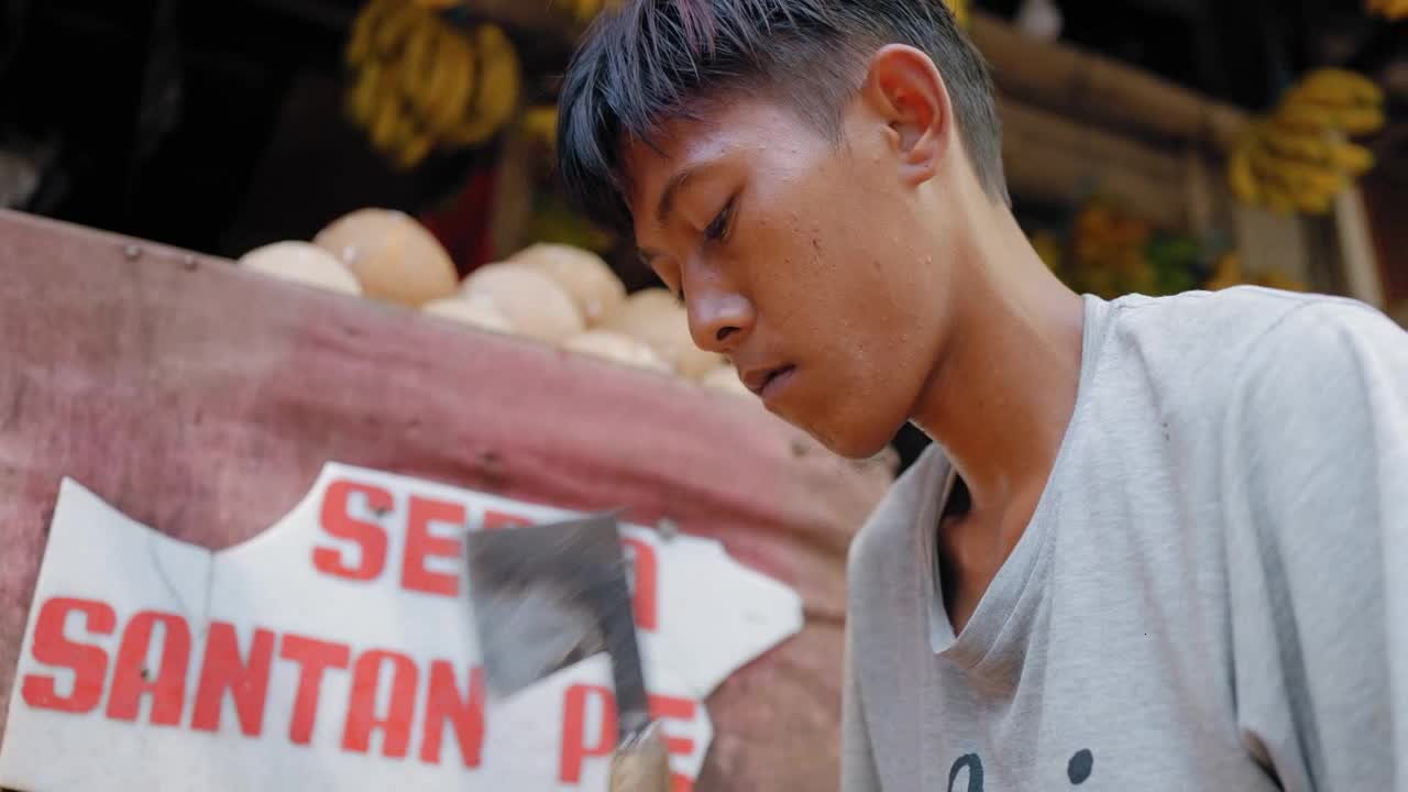 Low Angle Shot of Young Man Shaving Coconut Coir Fibre