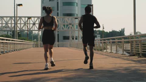 Men and women jog together in the street