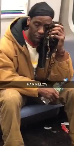 Hair pillow man in brown leans head agains handful of hair