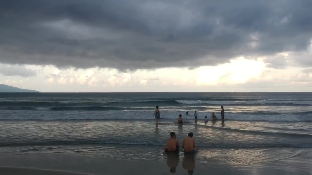Family on the beach at sunset