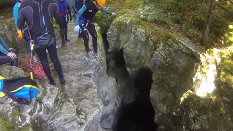 A man falls into water in a canyon