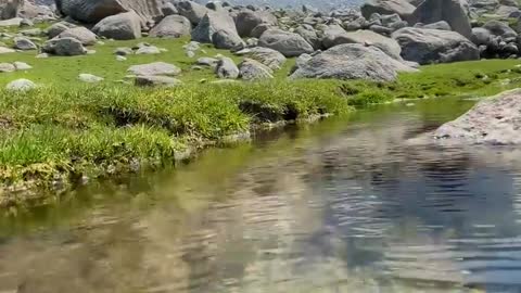 Mountain view from underwater.beautiful mountai with clear water .