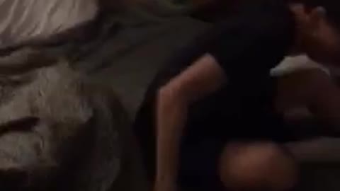 Guy black shirt jumps on sleeping friend