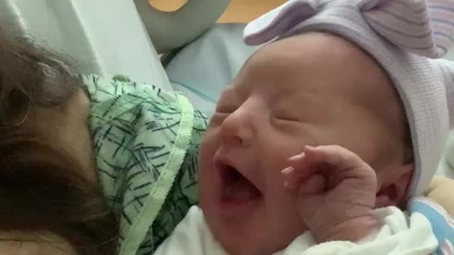 Hours old assertive newborn baby flicks off the world