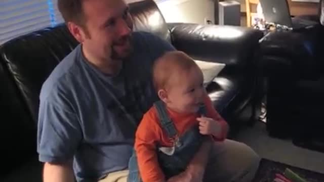 Little baby laughing at the Wii