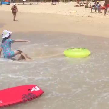 White bucket hat girl tossed around yellow floatie at beach