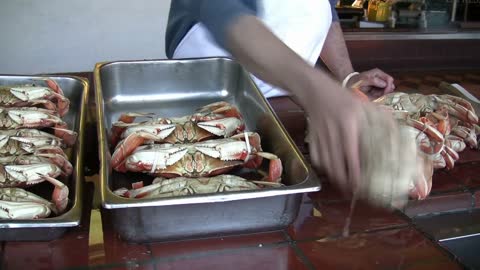 Loading Crabs into Metal Container