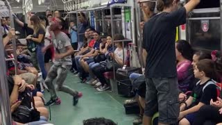 Subway performer dances in subway train with rollerskates to little mermaid song "under the sea"