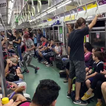 Subway performer dances in subway train with rollerskates to little mermaid song "under the sea"