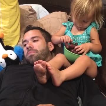 Adorable 2 year old feeds her daddy grapes