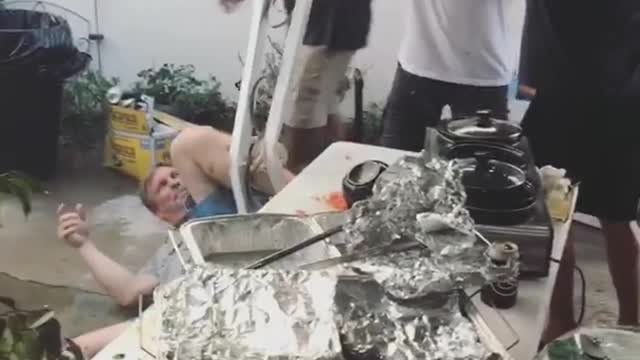 Youre kidding man tries to jump on pole but brings awning down on table of food