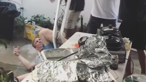 Youre kidding man tries to jump on pole but brings awning down on table of food