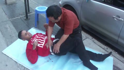 Luodong Massages Black Man On Sidewalk