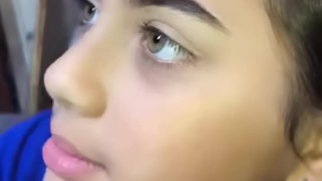 Trying a natural makeup look on her little sister
