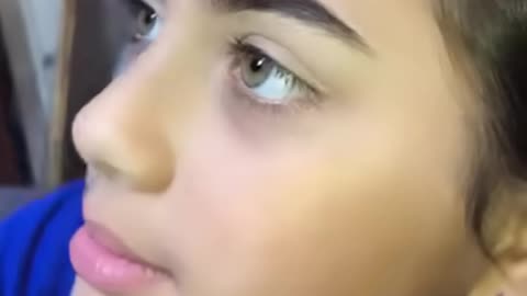 Trying a natural makeup look on her little sister
