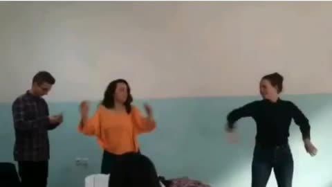 Music orange shirt girl dancing accidentally spins into boy in classroom