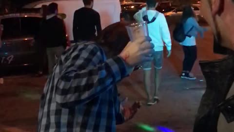 Music guy checkered shirt drinking and dancing