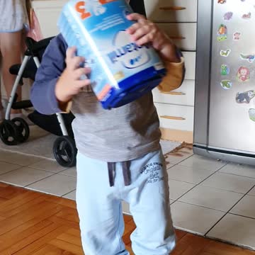 Baby is playing with a box