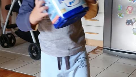 Baby is playing with a box