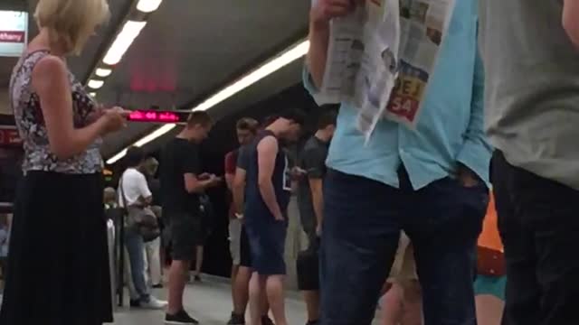 Man in blue shirt stares at two girls