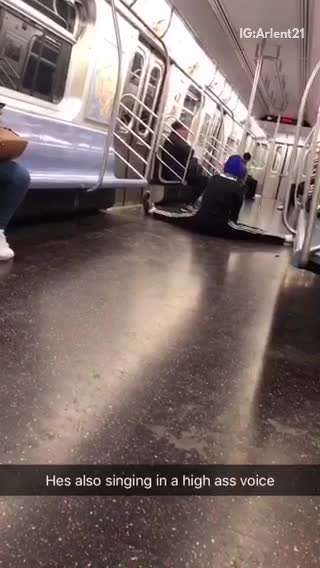 Man in blue beanie and does splits on subway