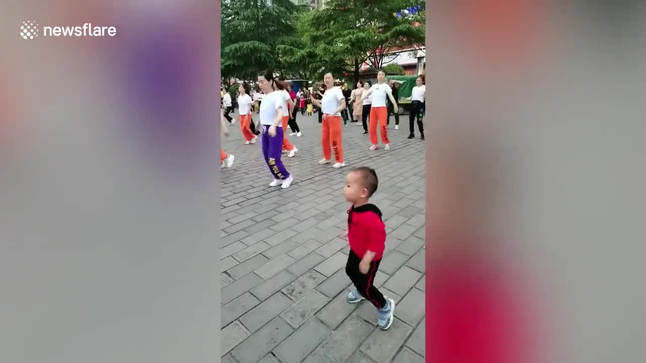 Toddler nails dance routines performed by group of women at Chinese park
