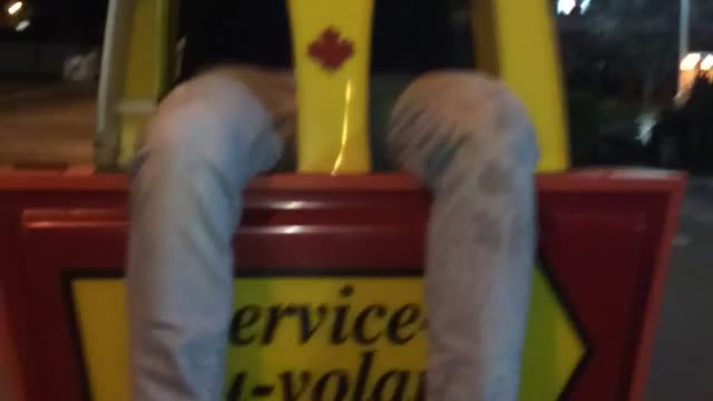 Glasses guy sits on mcdonald's sign