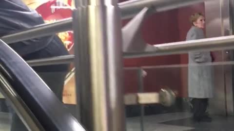 Beanie and glasses man sleeps on escalator