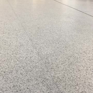 Man walks very slowly at train station