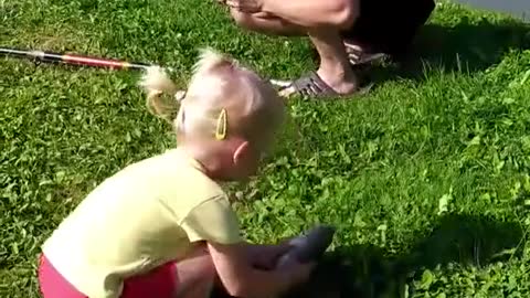 The little girl catches fish