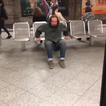 A man going up and down on subway station chair