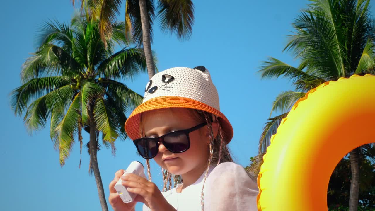 Little girl filming herself on vacations