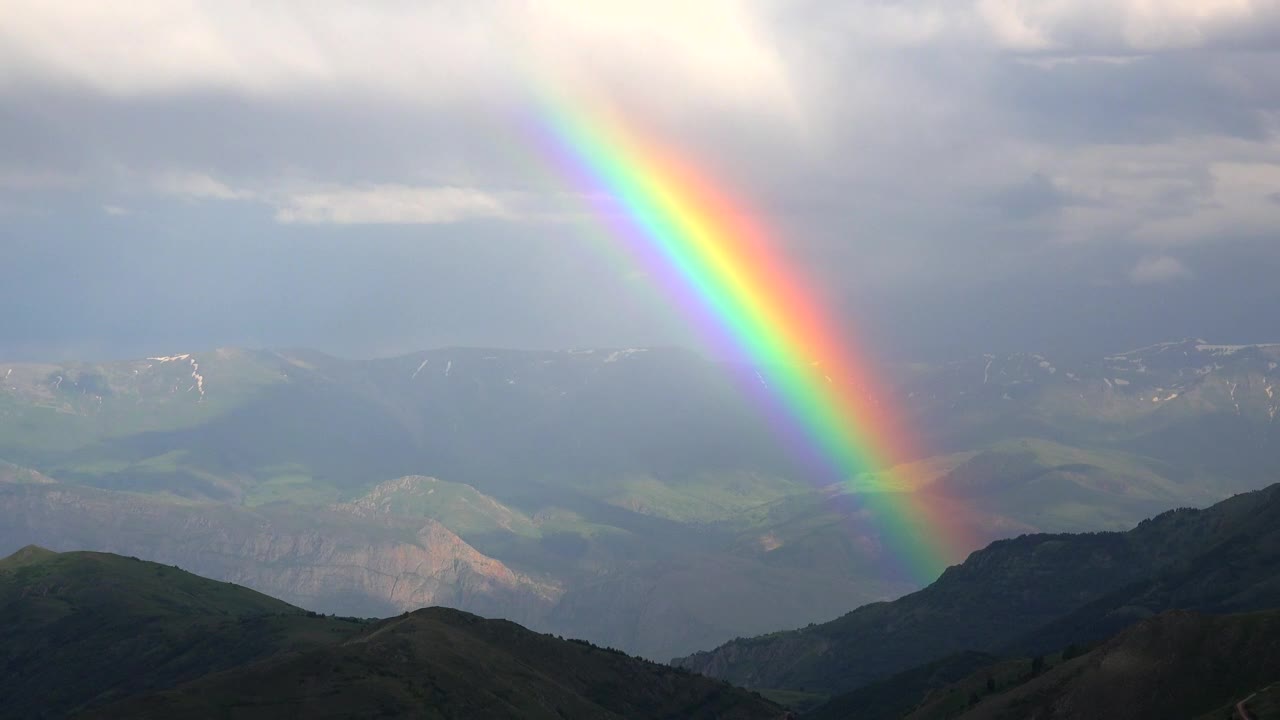 Rainbow glowing in the mountains