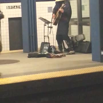 Basket head guy plays guitar in subway
