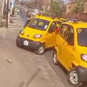 Taxi drivers smash a Bajaj Qute Bolt Lite vehicle