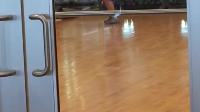 Guy juggling fedora hats gym