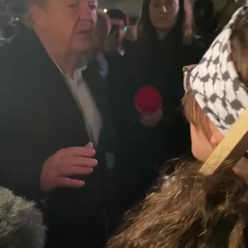 Denmark’s F.A.M Lars Løkke Rasmussen talking with a Palestinian anti-Israel protester