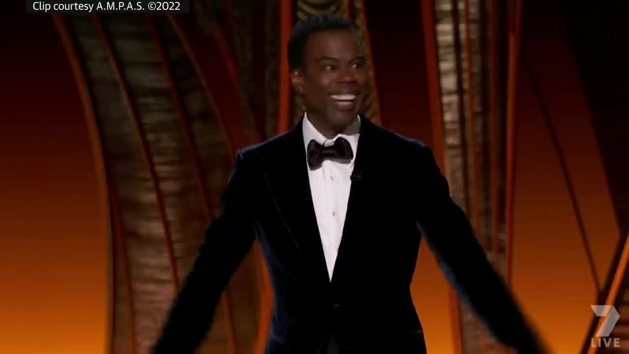 The uncensored moment will smith snacks chris rock on stage at the Oscars