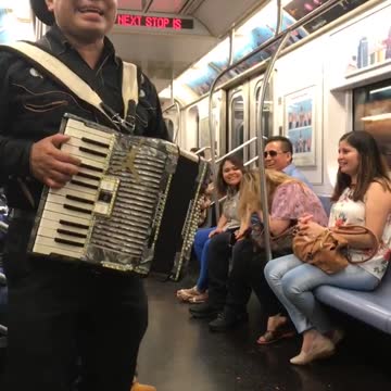 Men singing in spanish on train