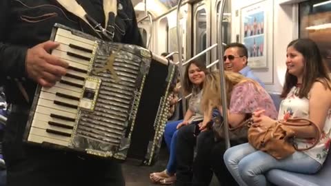 Men singing in spanish on train