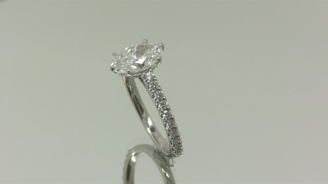 An oval Diamond set in a custom engagement ring.