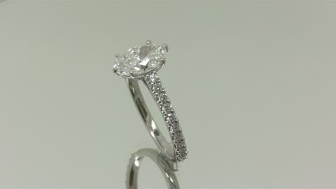 An oval Diamond set in a custom engagement ring.