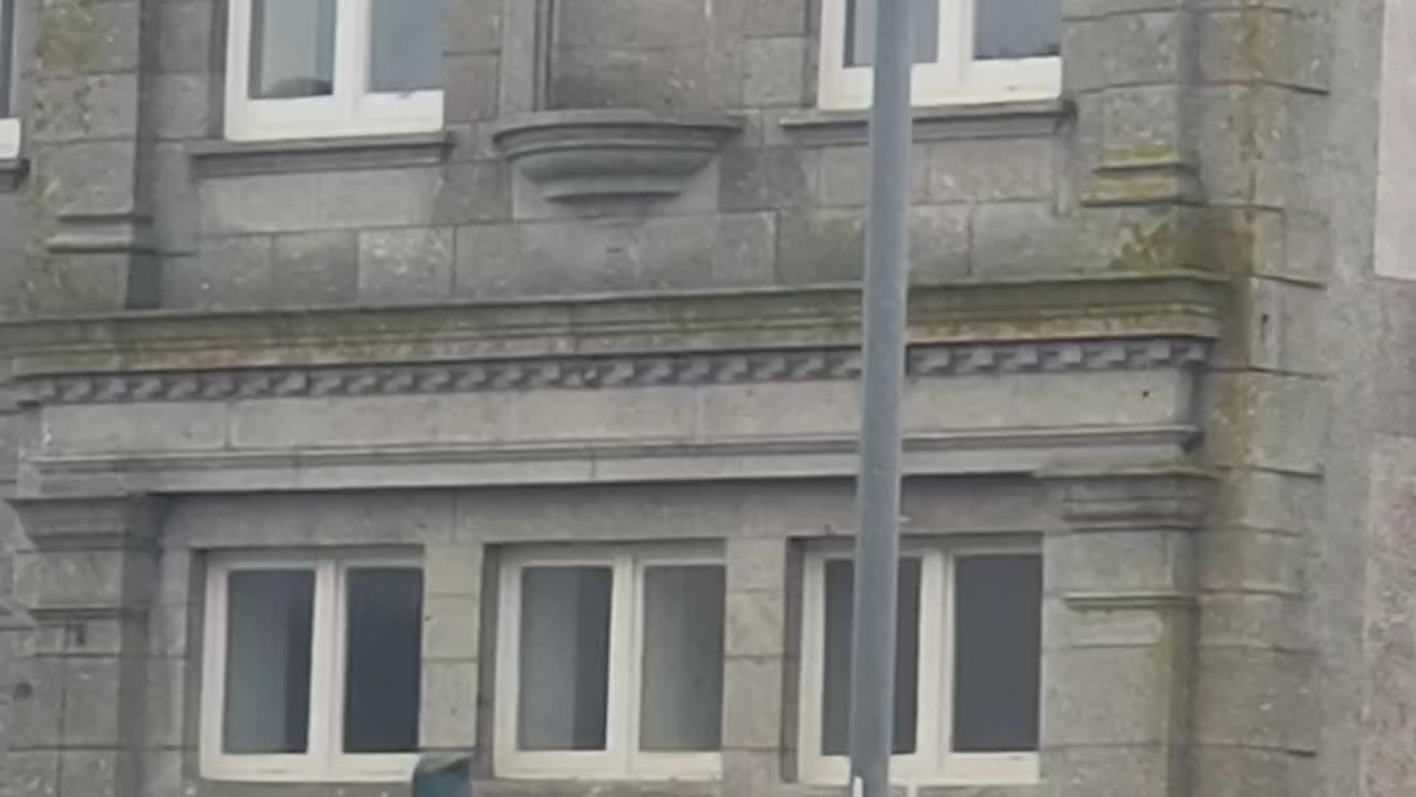 Reflecting on the Unionist Club building in Penzance.